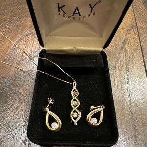 Kay Jewelers 10k gold 3 diamond floating swirl necklace and earrings